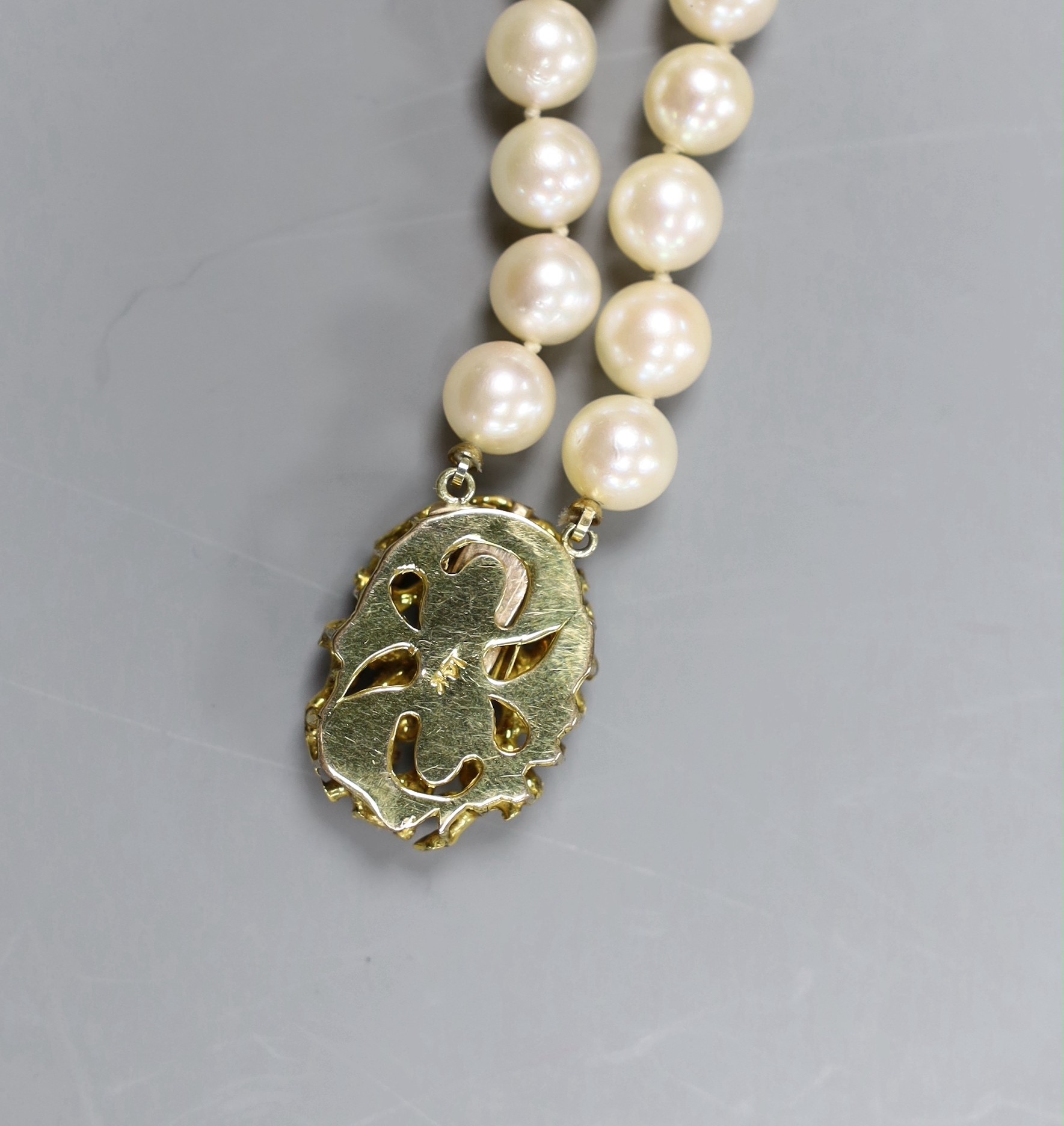 A two strand cultured pearl necklace with 14ct gold and turquoise set clasp, 33cm